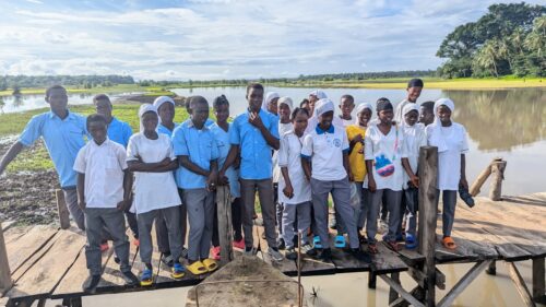 Image of pupils standing on a bridge connecting Katic Wallah and Gbainty Wallah, Sierra Leone