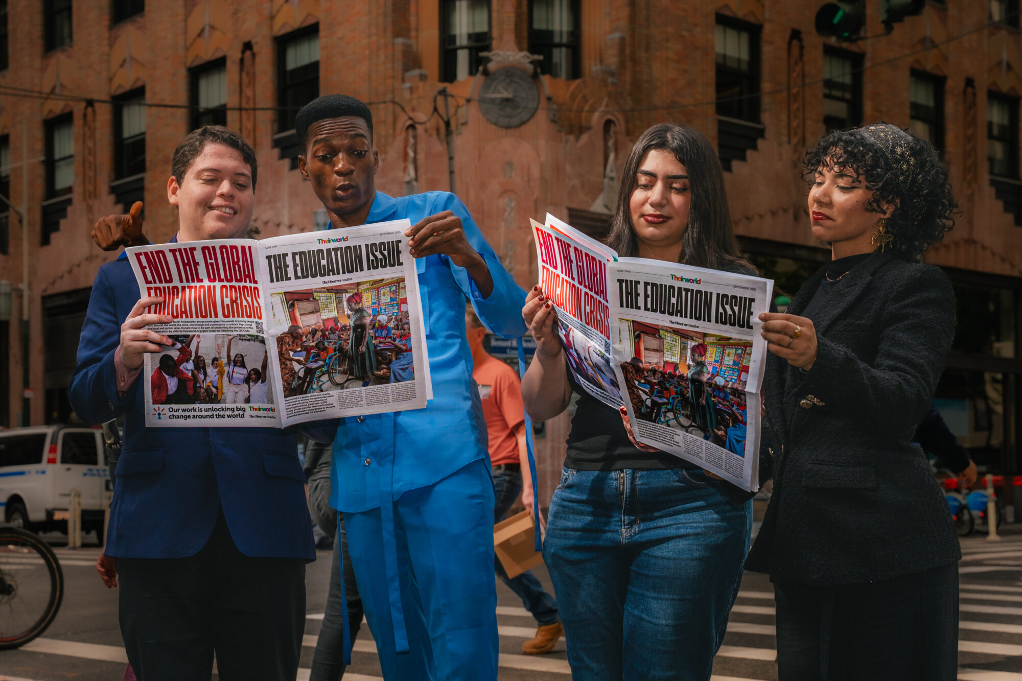 Four Global Youth Ambassadors reading The Education Issue