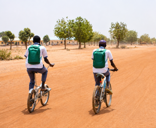 Nazifi Usman and Aliyu Abdullahi leave school to return home after classes. Please note that this image has had minor alterations.