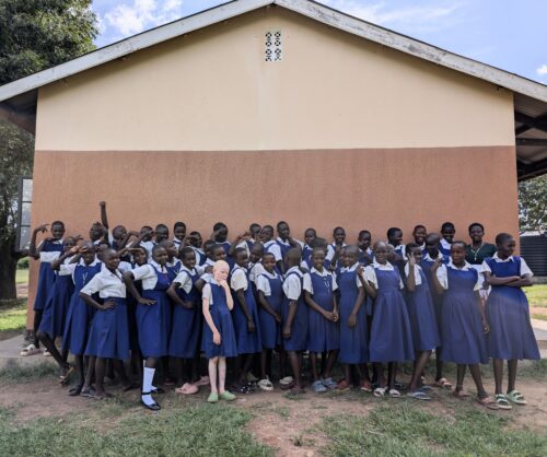 Teacher Margaret Abitekaniza (far right) with her students