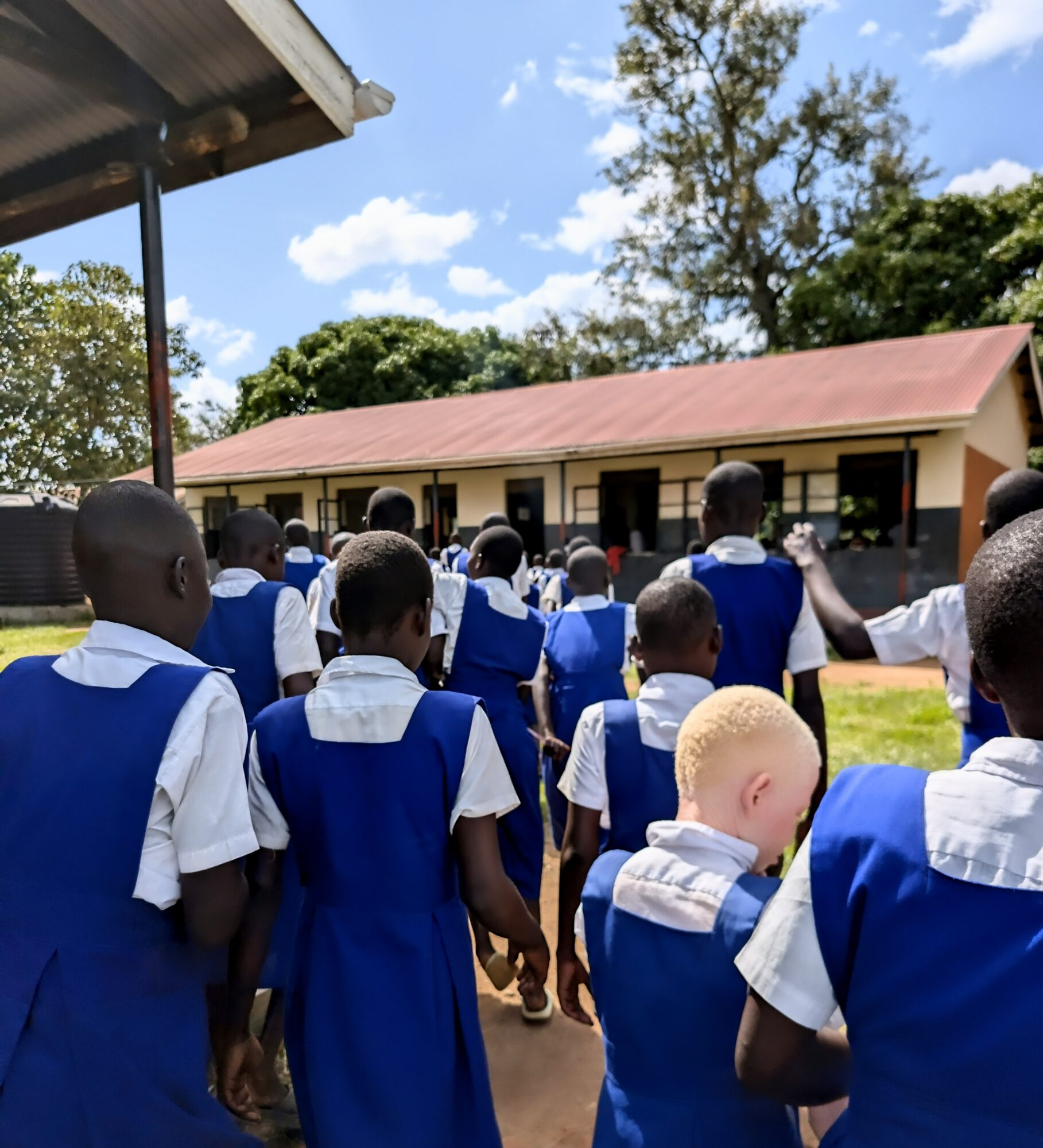 Margaret's students walk between their classrooms at Mukongoro Rock Primary School in Uganda